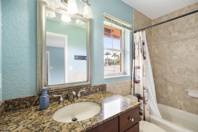 full bathroom featuring toilet, vanity, and shower / bathtub combination with curtain