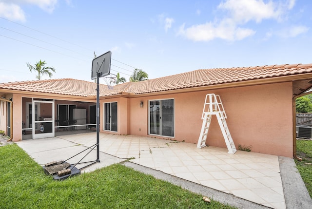 rear view of property with a patio area and a sunroom