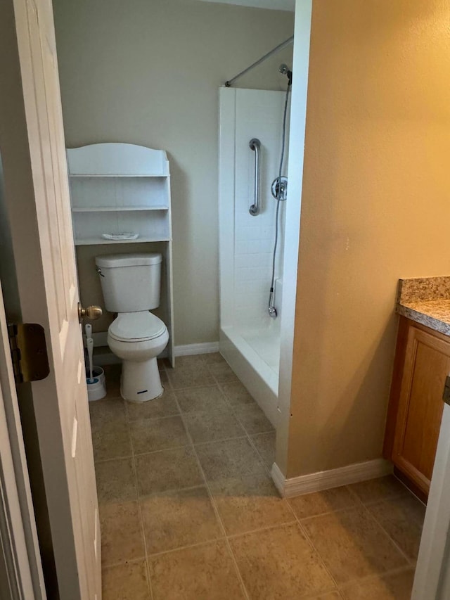 bathroom with walk in shower, vanity, tile patterned flooring, and toilet