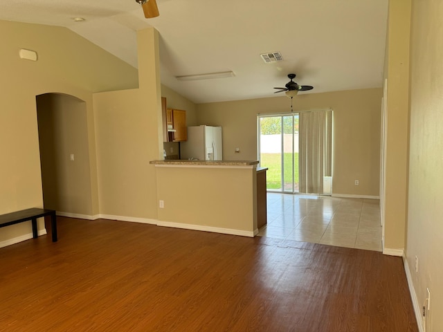 unfurnished living room with lofted ceiling, light hardwood / wood-style flooring, and ceiling fan