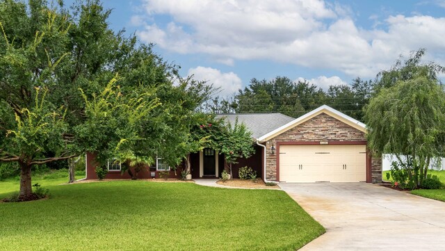 view of front of home with a garage and a front lawn