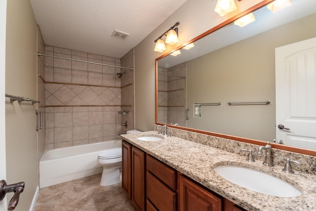 bathroom with shower / bath combination, visible vents, a sink, and double vanity