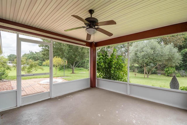 unfurnished sunroom with ceiling fan