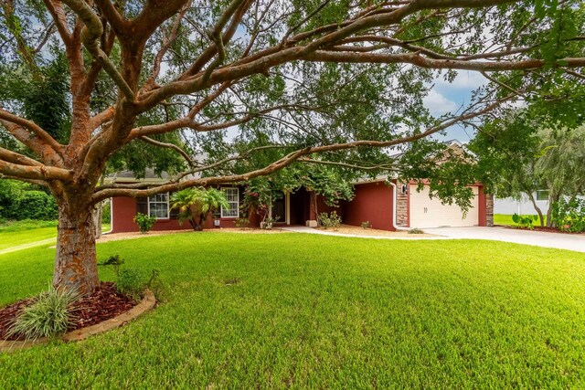 view of front of house with a garage and a front lawn