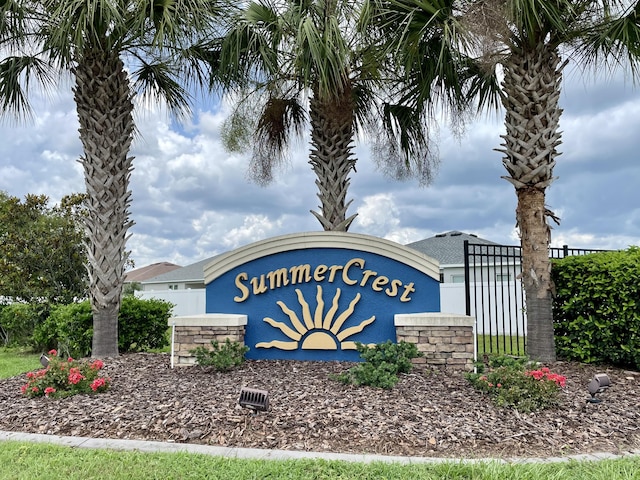 community / neighborhood sign with fence