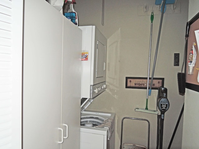 laundry room with stacked washing maching and dryer