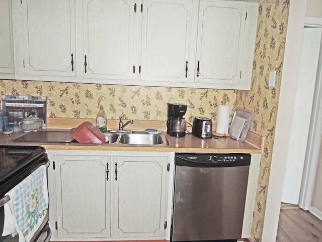 kitchen with black electric range, white cabinetry, stainless steel dishwasher, and light hardwood / wood-style flooring