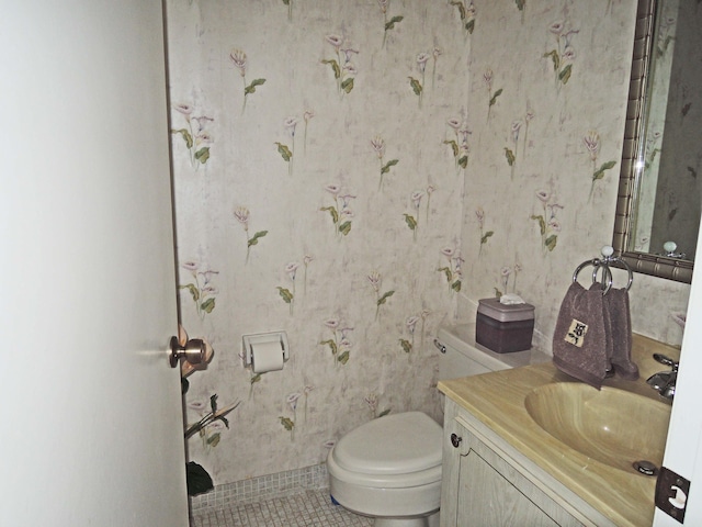 bathroom with vanity, tile patterned floors, and toilet