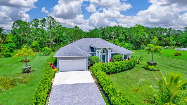 view of front of property featuring a garage and a front yard