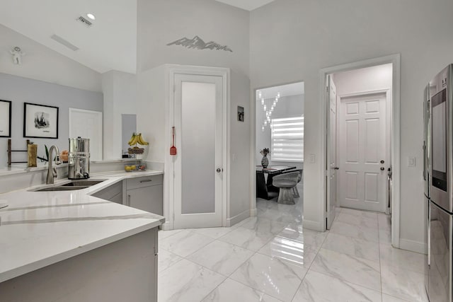 bathroom with high vaulted ceiling, tile patterned floors, and sink