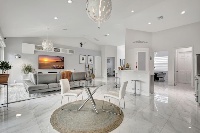 tiled living room with high vaulted ceiling and a chandelier