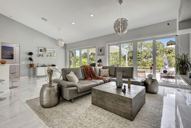 living room featuring light tile patterned flooring, high vaulted ceiling, and plenty of natural light