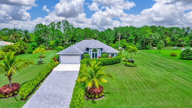 view of front of property featuring a garage and a front lawn