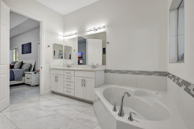 bathroom featuring dual vanity, tile patterned floors, and tiled tub