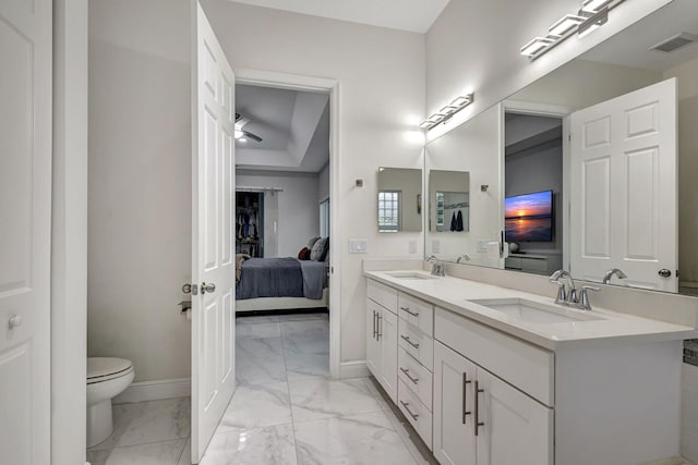 bathroom featuring double vanity, tile patterned flooring, and toilet