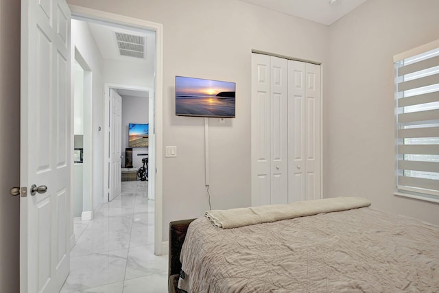 bedroom featuring light tile patterned floors and a closet