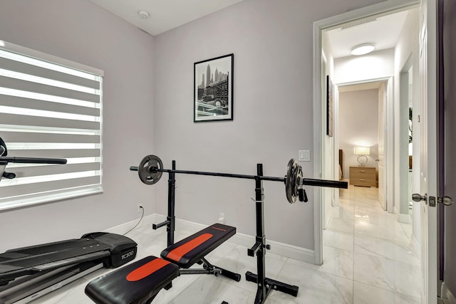 exercise room featuring light tile patterned flooring