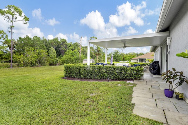 view of yard with a patio area, outdoor lounge area, and ceiling fan