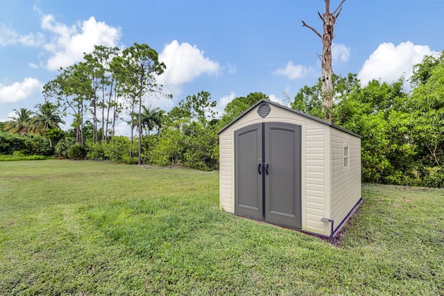 view of outbuilding with a lawn