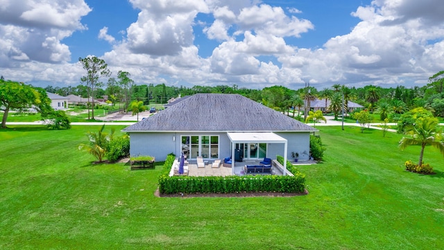 rear view of house featuring a patio and a lawn