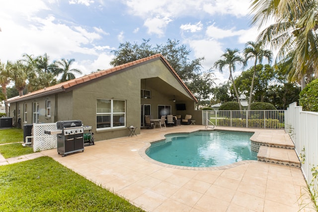 view of pool with grilling area and a patio area