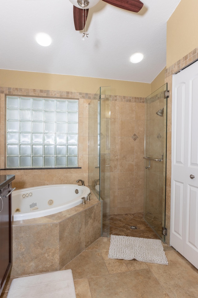 bathroom featuring ceiling fan, vanity, plus walk in shower, and tile patterned flooring