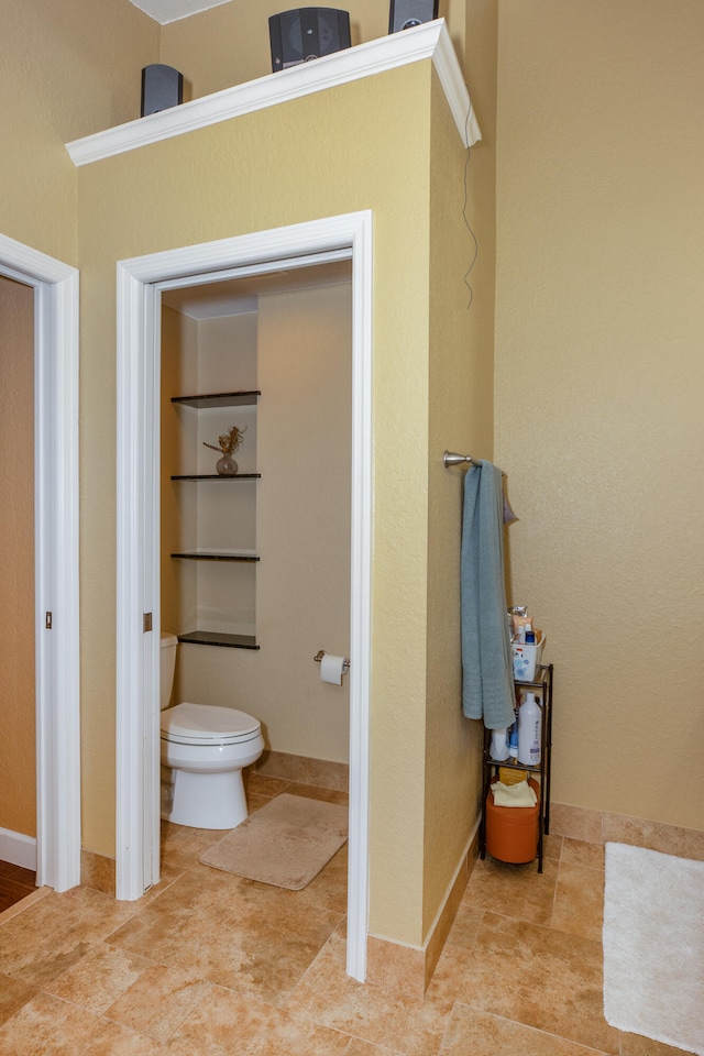 bathroom featuring toilet and tile patterned flooring