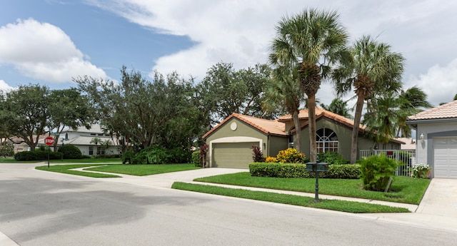 view of front of house featuring a front yard and a garage