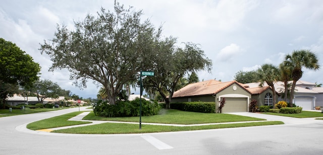 view of front facade with a front yard and a garage