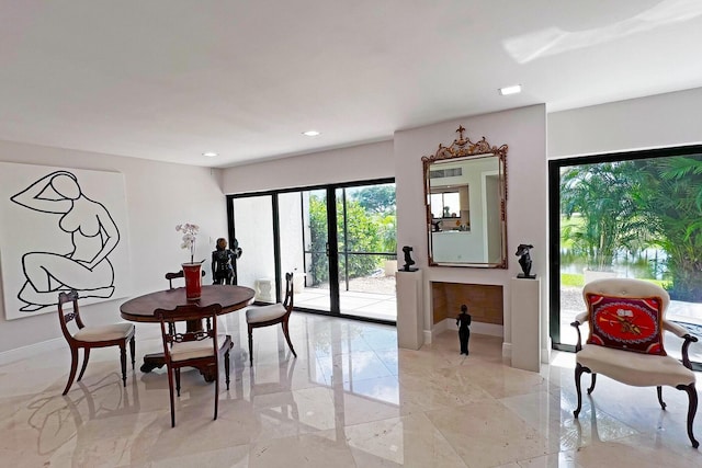 dining area featuring recessed lighting, marble finish floor, and baseboards