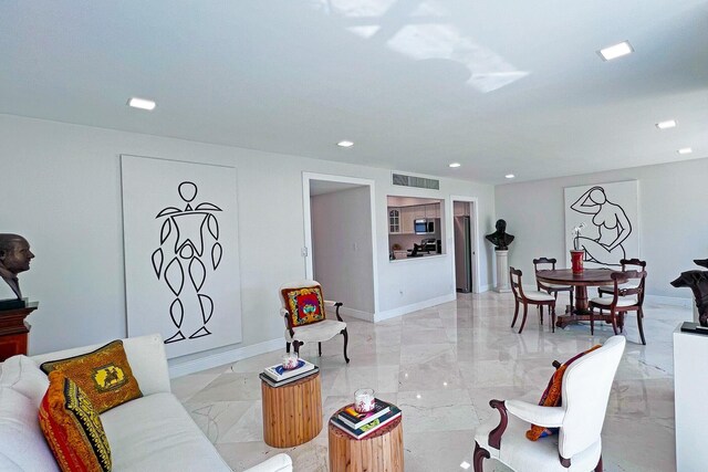 sitting room featuring marble finish floor and baseboards