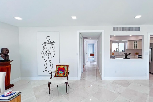 sitting room featuring marble finish floor, baseboards, visible vents, and recessed lighting