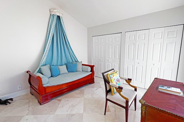 living area with lofted ceiling and baseboards