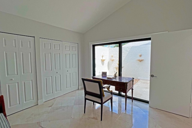 office area with vaulted ceiling and marble finish floor