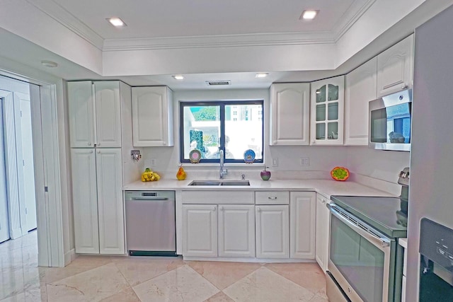 kitchen with glass insert cabinets, appliances with stainless steel finishes, white cabinets, and a sink