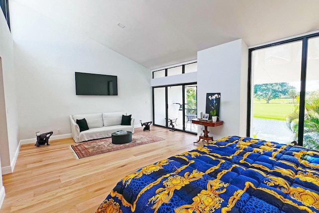 bedroom with high vaulted ceiling, access to outside, baseboards, and wood finished floors