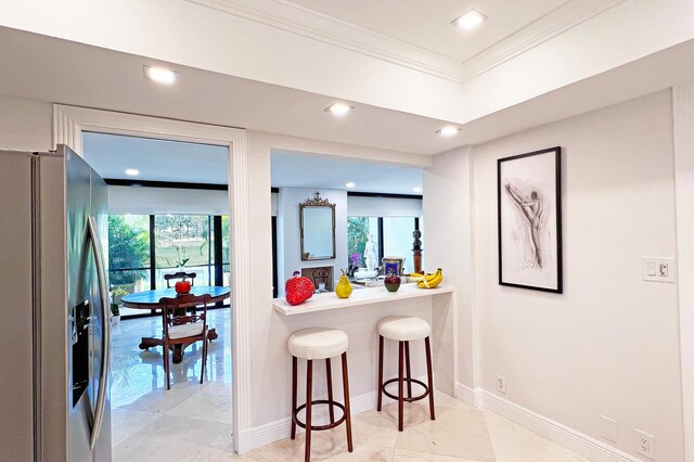 bedroom with visible vents, a towering ceiling, baseboards, and wood finished floors