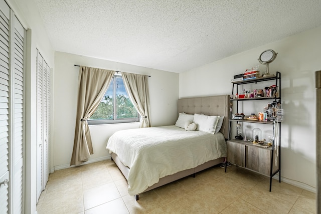 bedroom with light tile patterned floors and a textured ceiling