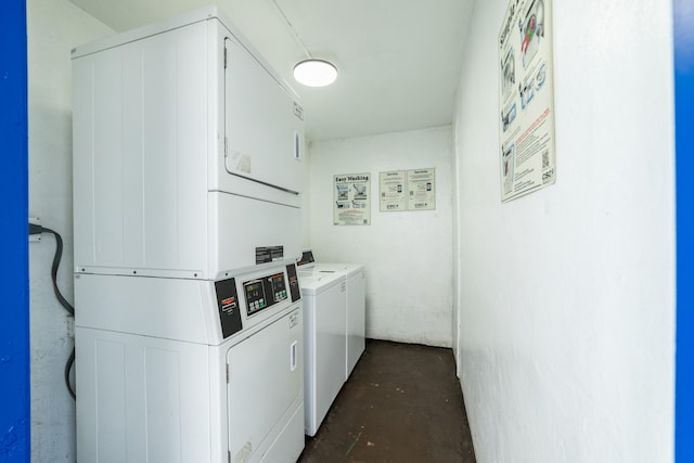 clothes washing area featuring stacked washer and clothes dryer