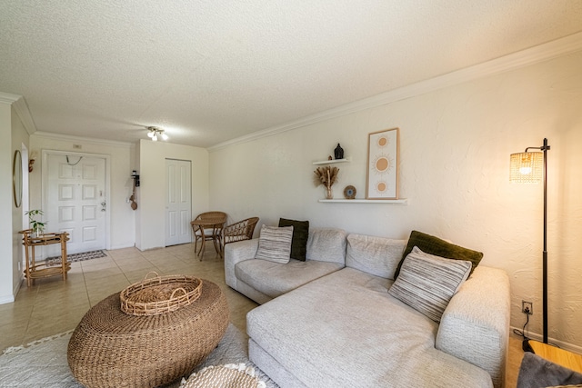 living room with a textured ceiling, crown molding, and light tile patterned floors