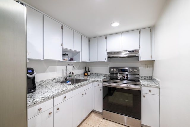 kitchen with stainless steel range with electric stovetop, white cabinets, sink, and light tile patterned floors