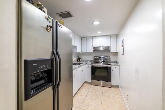 kitchen with appliances with stainless steel finishes, light tile patterned floors, and sink