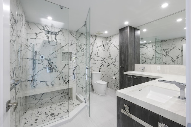 bathroom with vanity, toilet, an enclosed shower, and tile walls