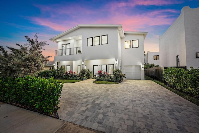 view of front of home featuring a garage and a balcony