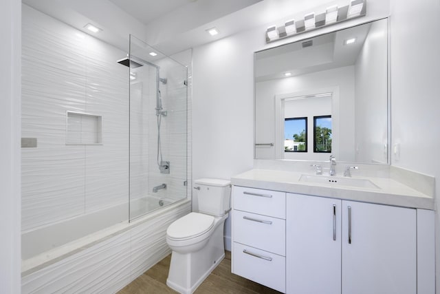 full bathroom featuring vanity, toilet, and tiled shower / bath