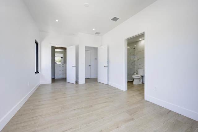 unfurnished bedroom featuring connected bathroom