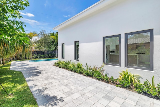 view of side of home featuring a patio