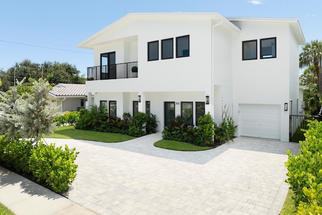 view of front of house with a garage and a balcony