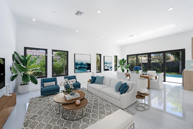 living room with concrete flooring and french doors