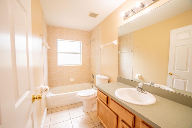 full bathroom featuring tiled shower / bath combo, vanity, tile patterned flooring, and toilet